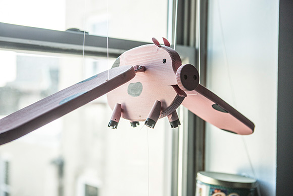 "When Pigs Fly" tiny pig sculptures all over Salzman's office