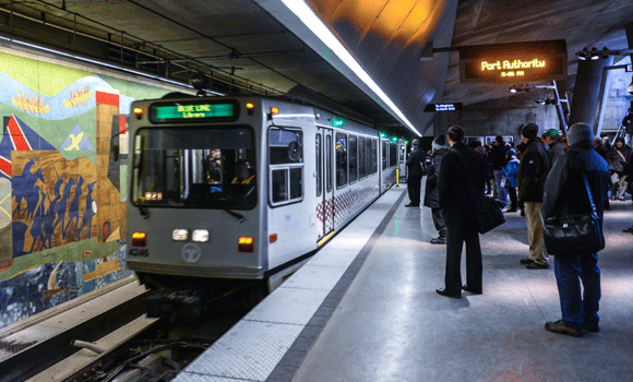 Commuters wait for the T